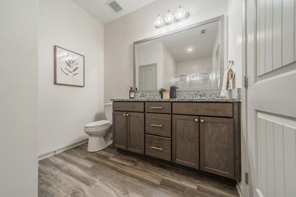 Modern bathroom with sleek fixtures in Pringle Square Apartments, luxury living in a Greystar property