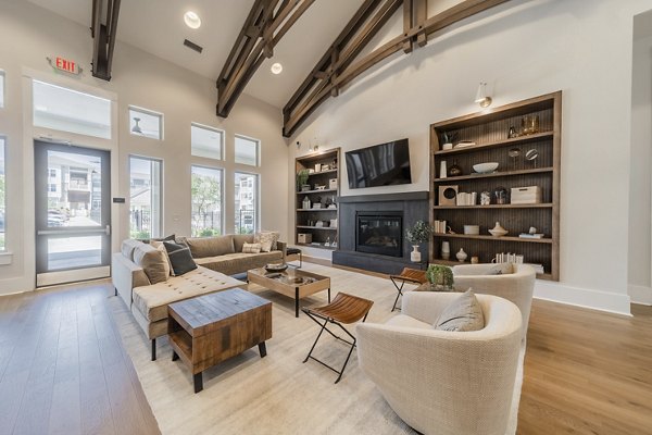 Modern clubhouse with game tables and plush seating at Pringle Square Apartments, offering luxury amenities and social space for residents