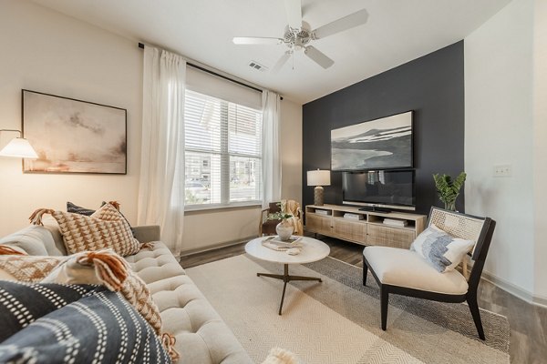 Living room with modern furnishings at Pringle Square Apartments, showcasing luxury interiors in the heart of a vibrant community
