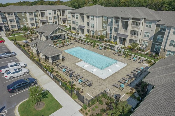 Outdoor pool with sun loungers at Pringle Square Apartments, luxury feature of Greystar's premium community living experience