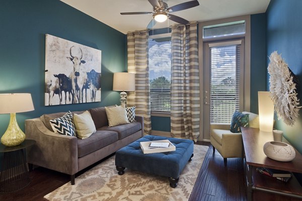 Cozy living room with modern decor at Echo Apartments featuring plush seating and natural light