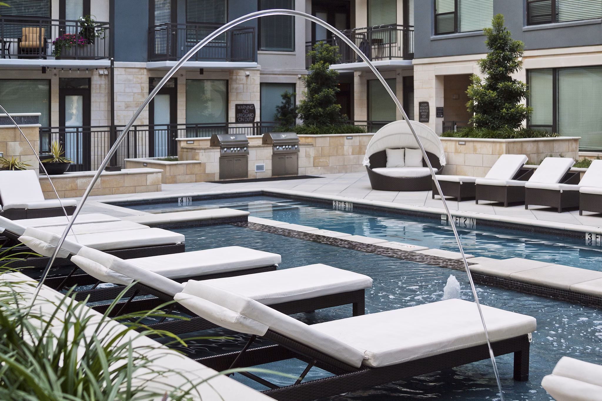 Luxurious poolside lounging area at Echo Apartments