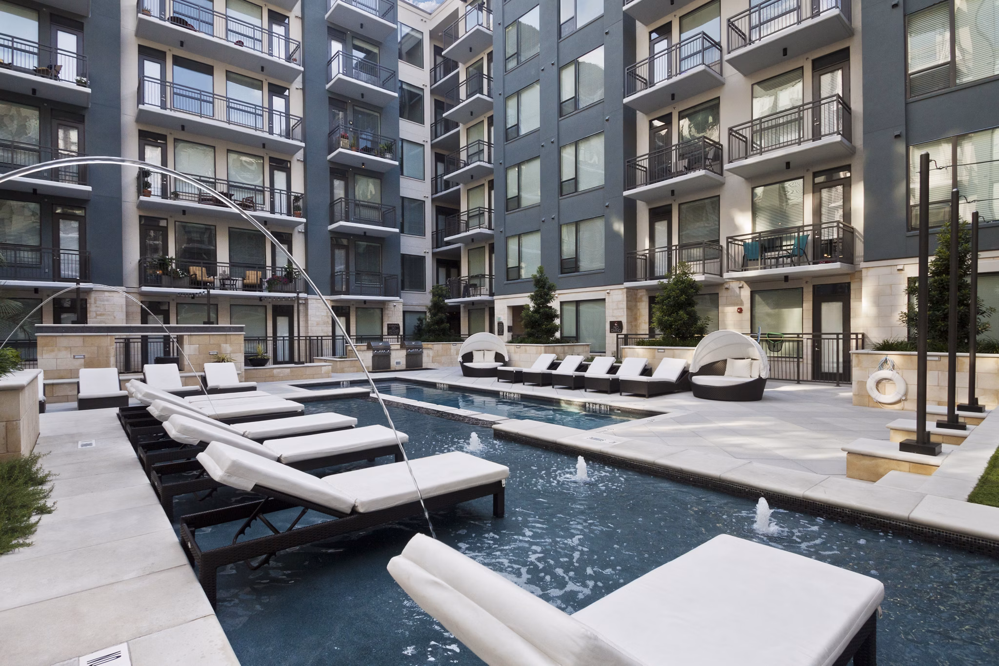 Rooftop pool with sun loungers offering city views at Echo Apartments, a luxury Greystar property