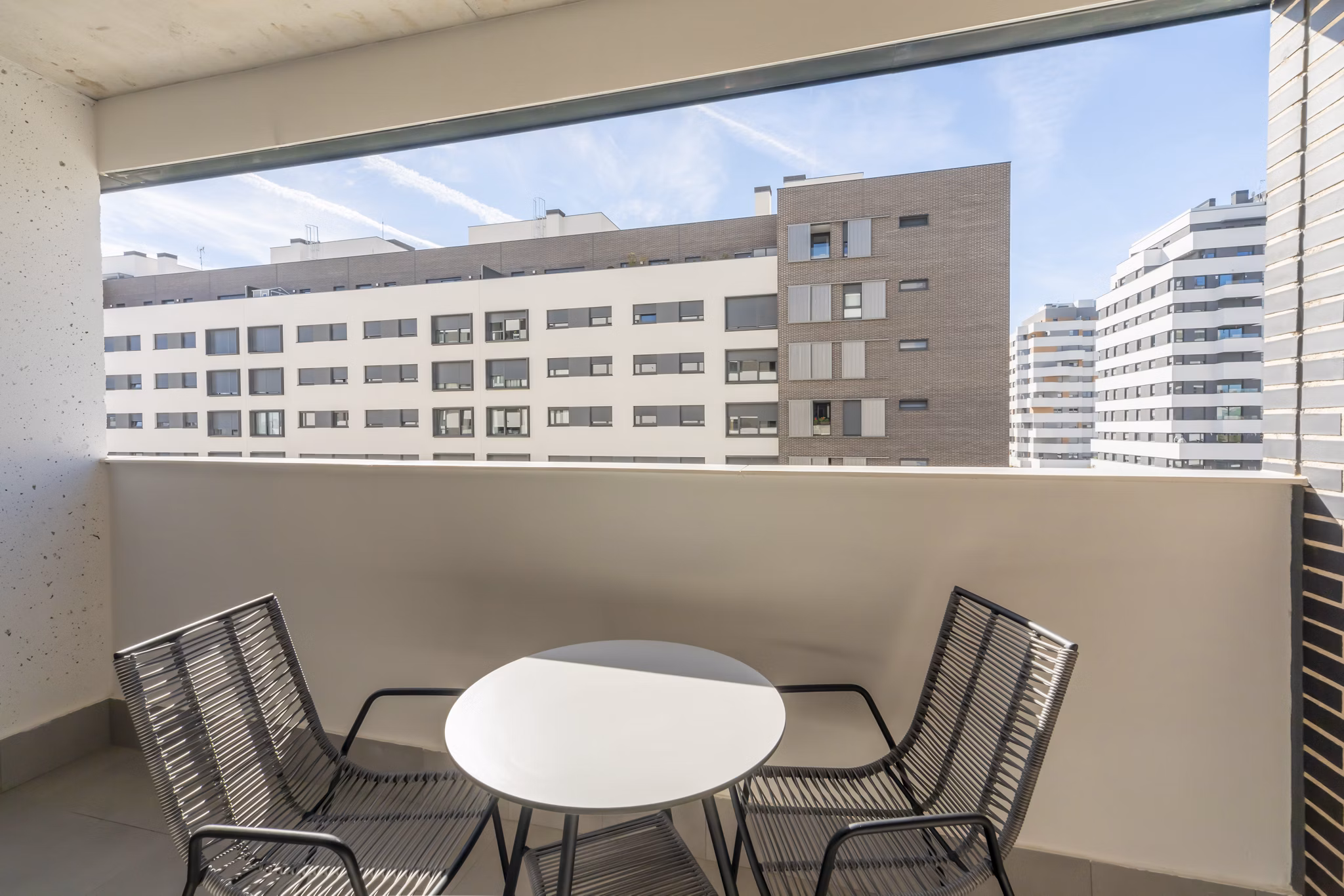 Private balcony with seating and an urban view at Be Casa Essential Canaveral.