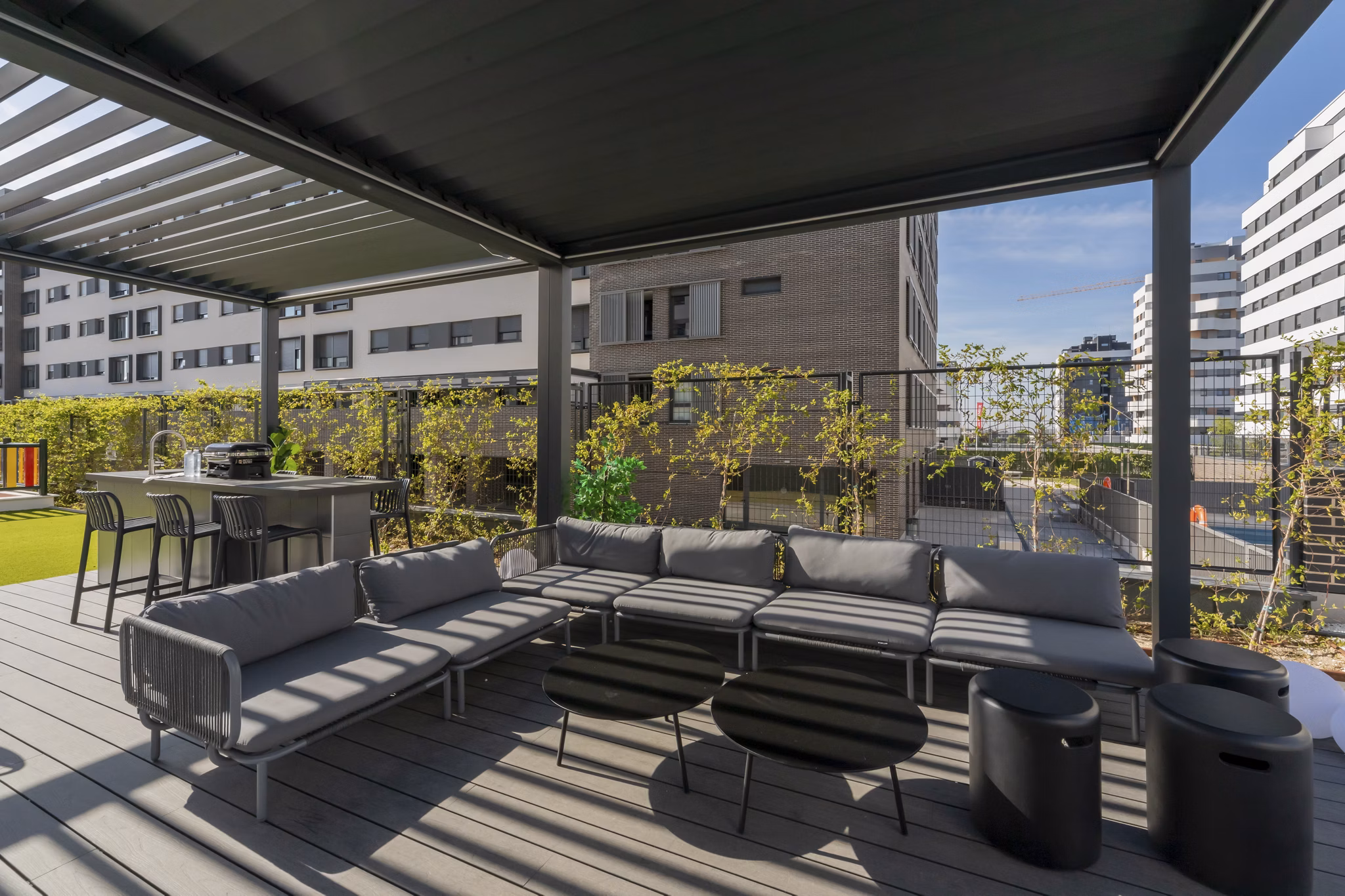 Outdoor recreational area with shaded seating and greenery at Be Casa Essential Canaveral.