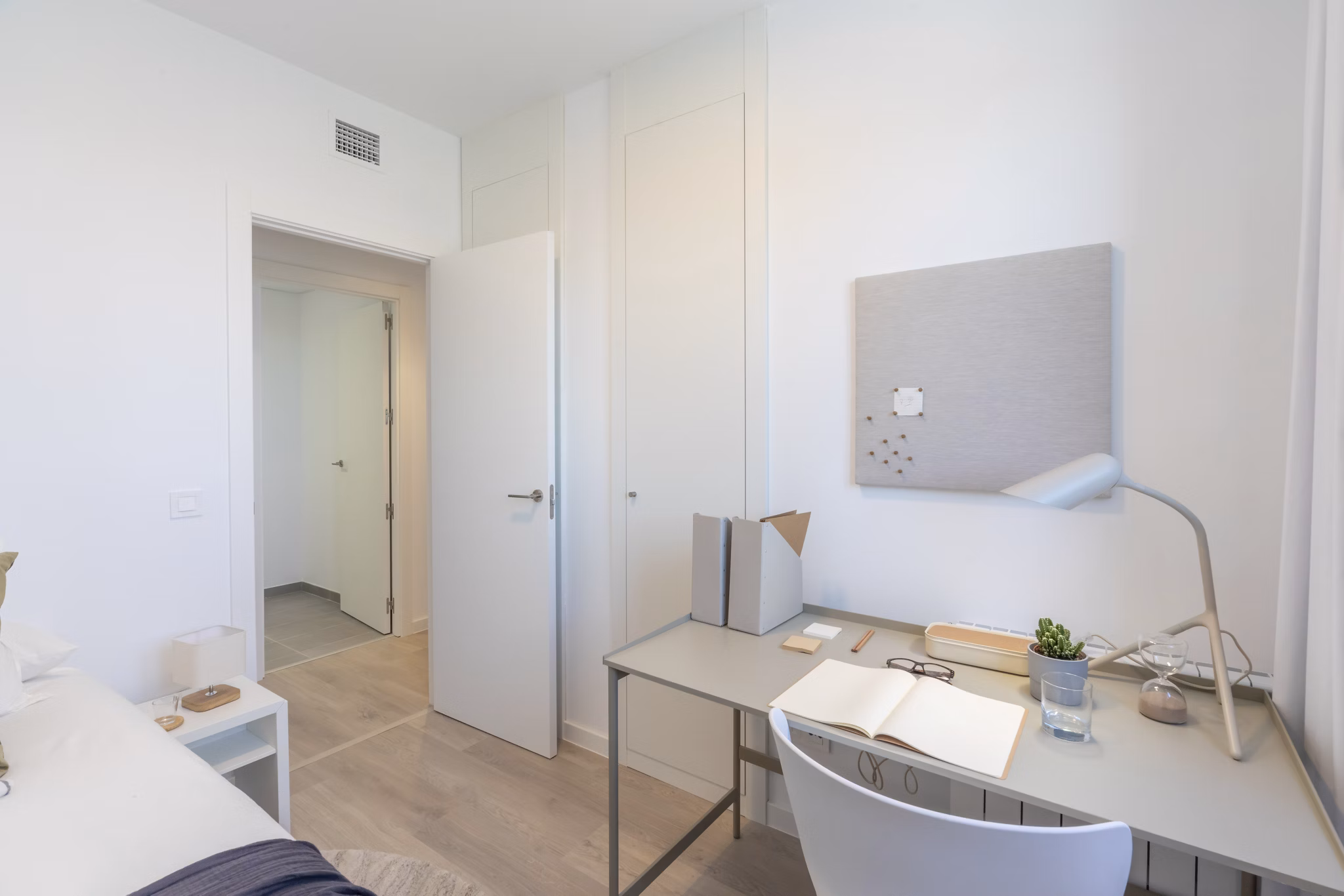 Charming bedroom with natural light and minimalist decor at Be Casa Essential Barajas.