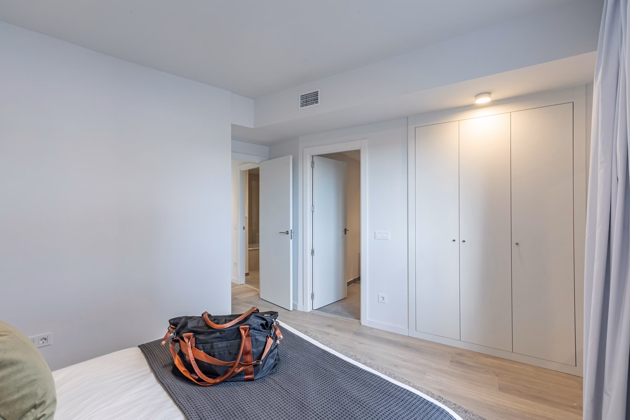 Well-lit bedroom with stylish decor and natural light at Be Casa Essential Barajas Bulevar.