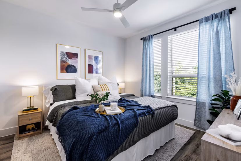 Cozy bedroom with modern furnishings at Crosstown Apartments, showcasing luxury living in a premier location