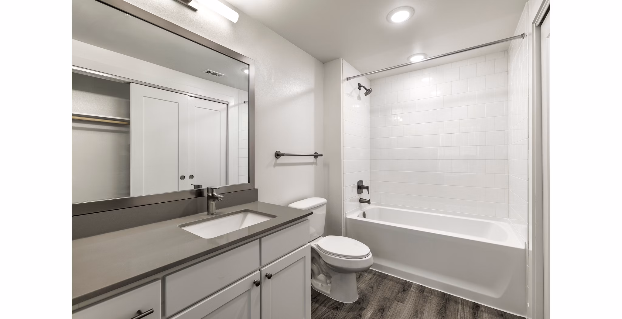 Elegant bathroom with marble countertops and modern fixtures at Crosstown Apartments