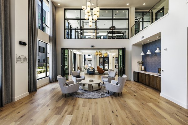 Stylish clubhouse with modern seating at Crosstown Apartments for resident gatherings and events