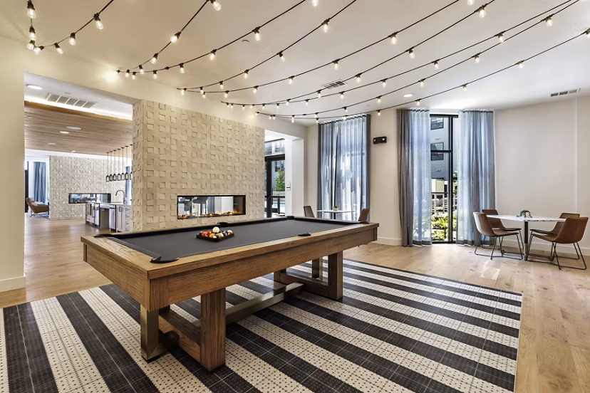 Clubhouse featuring modern design and ample seating at Crosstown Apartments