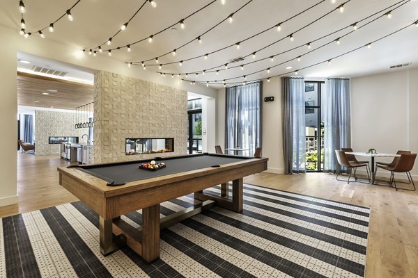 Clubhouse featuring modern design and ample seating at Crosstown Apartments