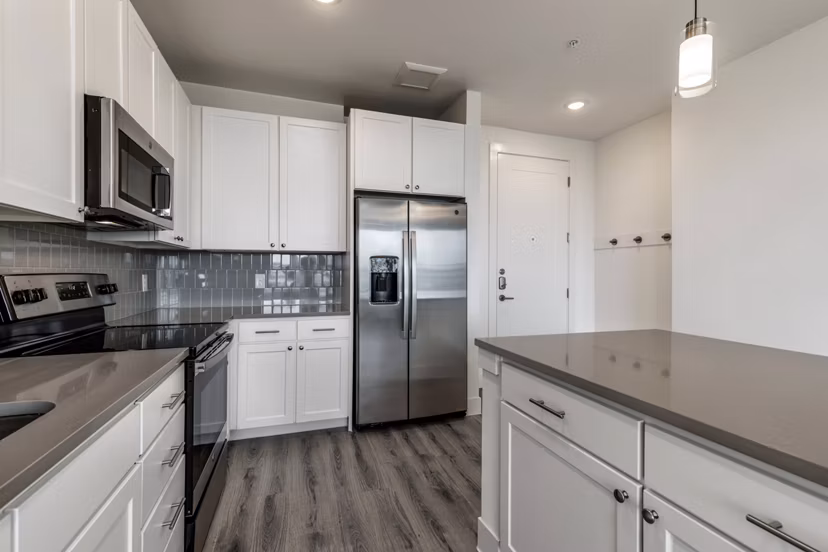 Modern kitchen with stainless steel appliances at Crosstown Apartments