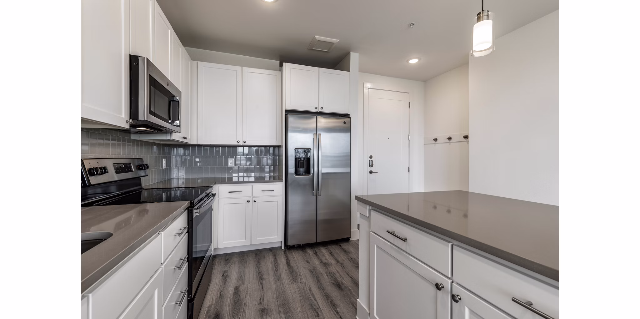 Modern kitchen with stainless steel appliances at Crosstown Apartments