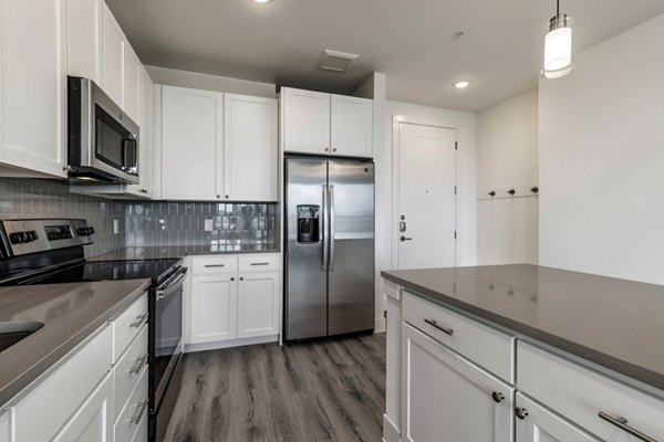 Modern kitchen with stainless steel appliances at Crosstown Apartments