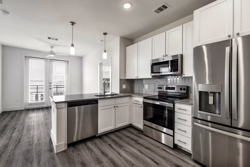 Modern kitchen with stainless steel appliances at Crosstown Apartments