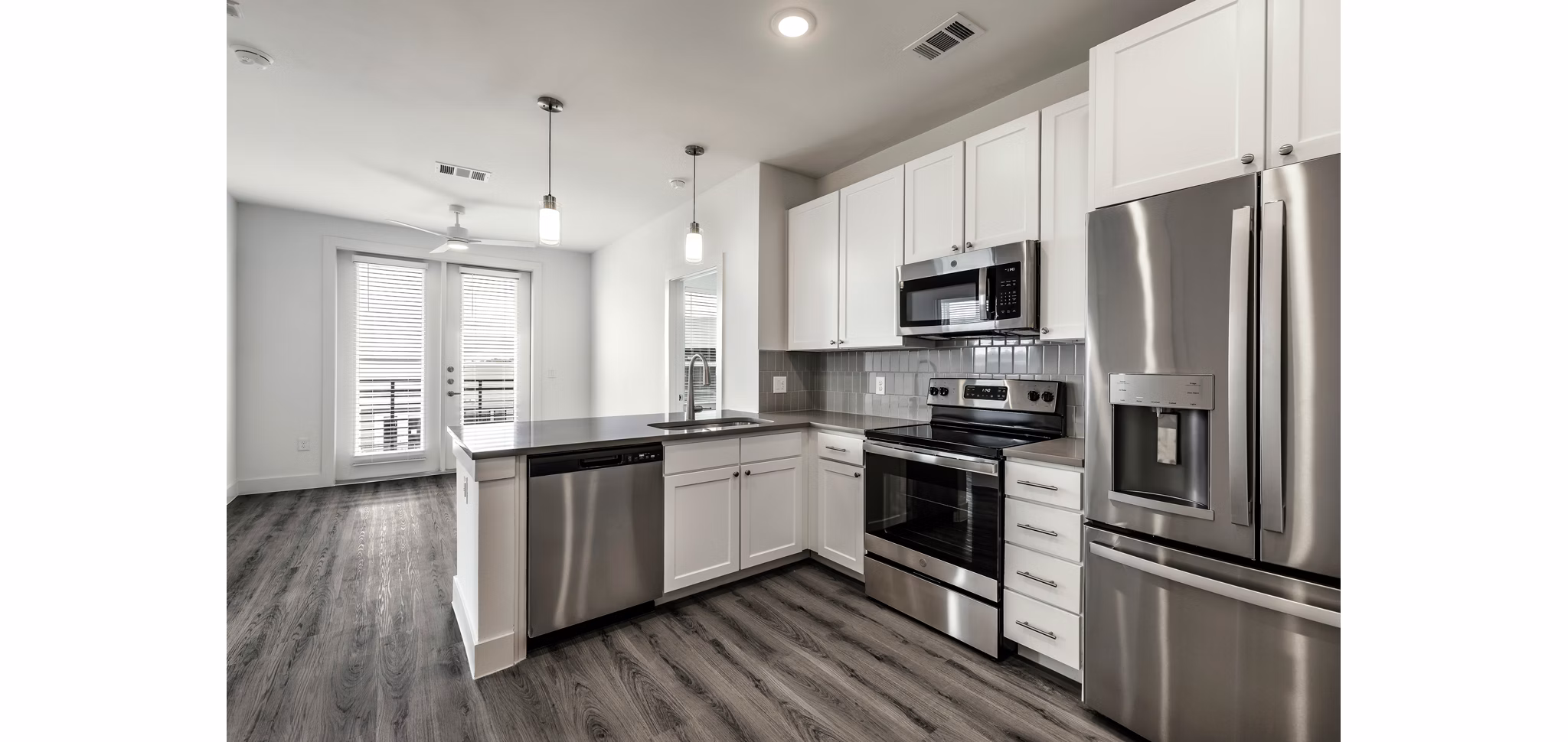 Modern kitchen with stainless steel appliances at Crosstown Apartments