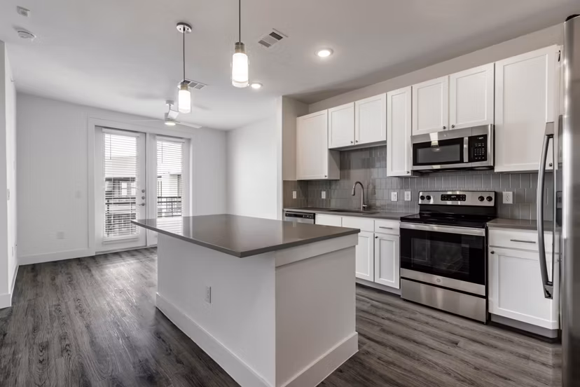 Modern kitchen with stainless steel appliances and granite countertops at Crosstown Apartments