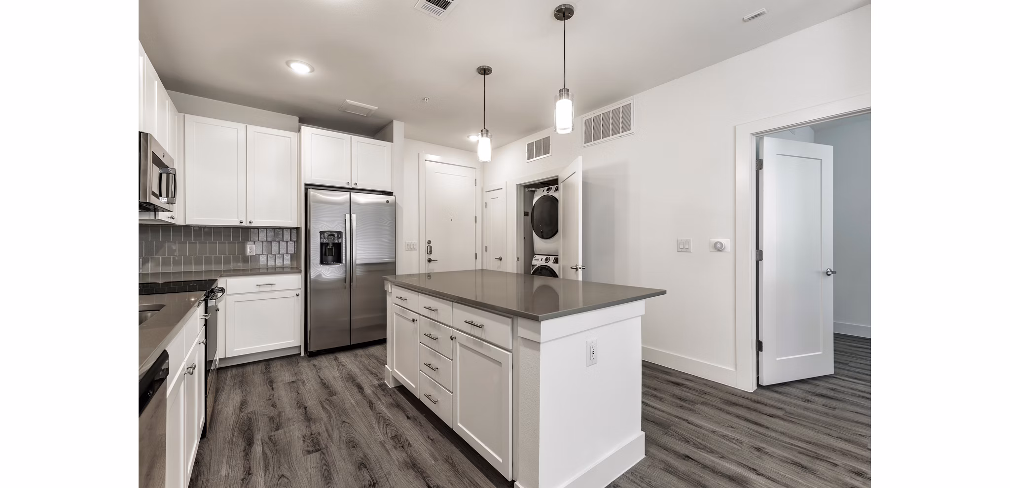 Modern kitchen with sleek cabinetry and stainless steel appliances in Crosstown Apartments