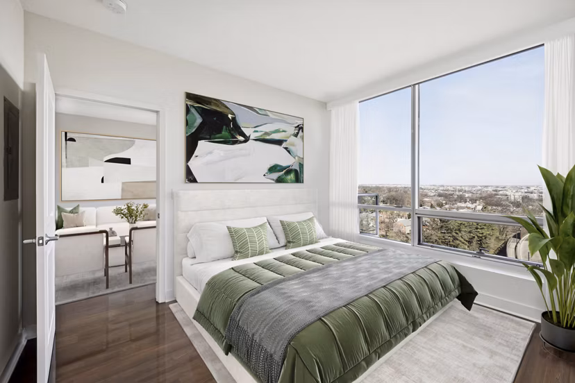 Cozy bedroom with contemporary design and large windows at Verde Pointe