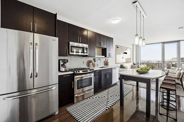 Modern kitchen with stainless steel appliances at Verde Pointe apartments