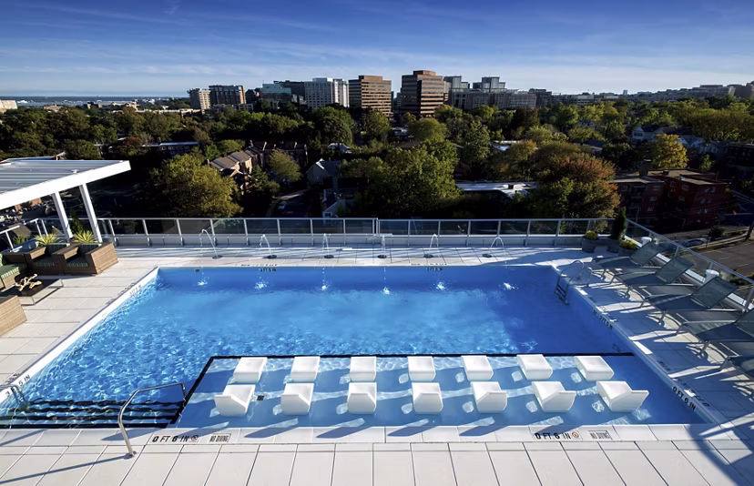 Luxurious outdoor pool with sun loungers at Verde Pointe apartments