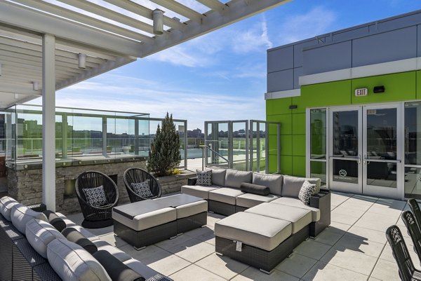 Rooftop lounge with seating and skyline views at Verde Pointe apartments