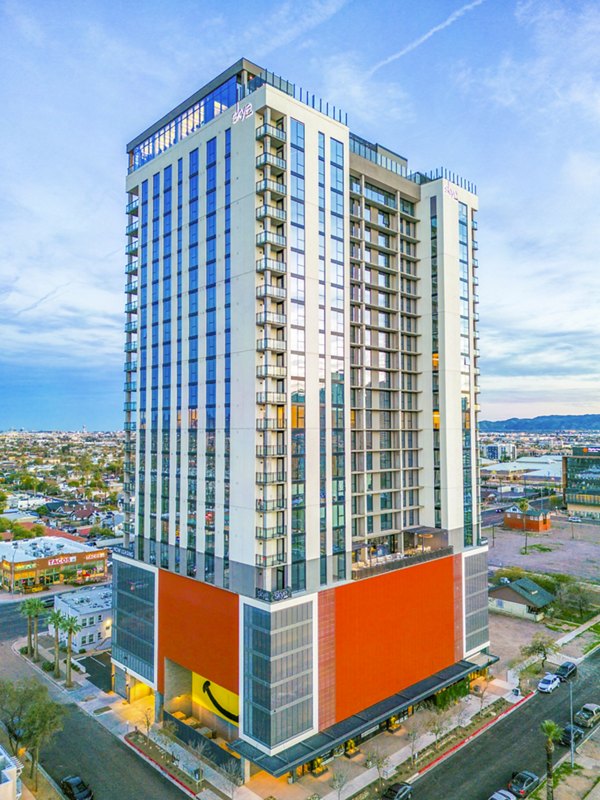 Skye on 6th Apartments: Sleek high-rise building in vibrant cityscape