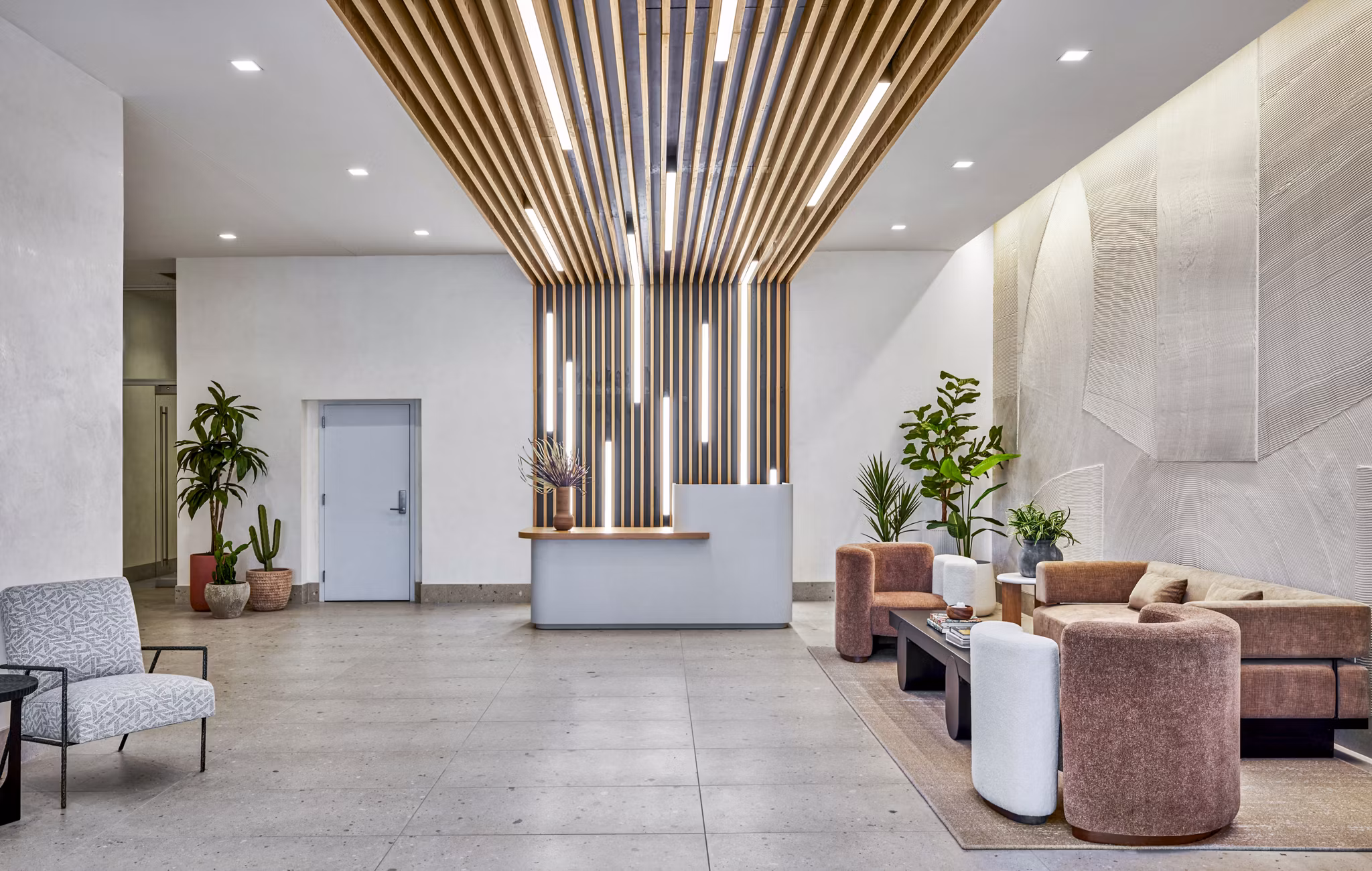 Stylish clubhouse and lobby at Skye on 6th Apartments with modern seating and decor, offering a luxurious welcome to residents and guests