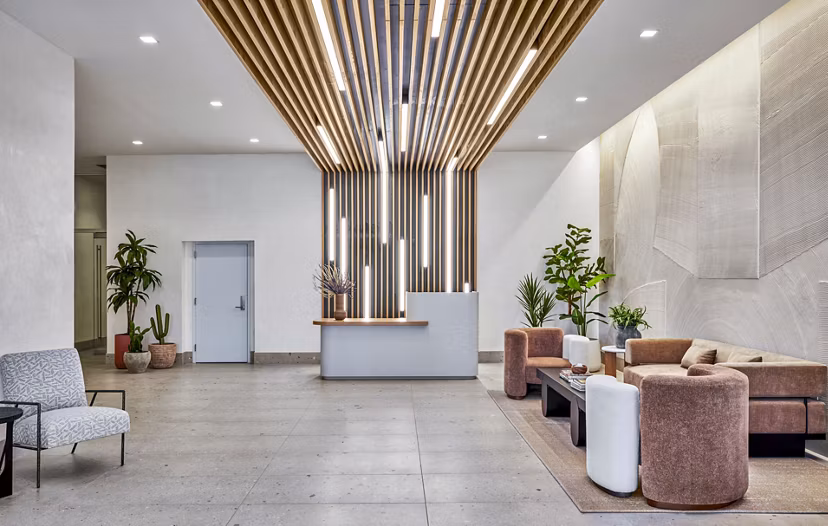 Stylish clubhouse and lobby at Skye on 6th Apartments with modern seating and decor, offering a luxurious welcome to residents and guests