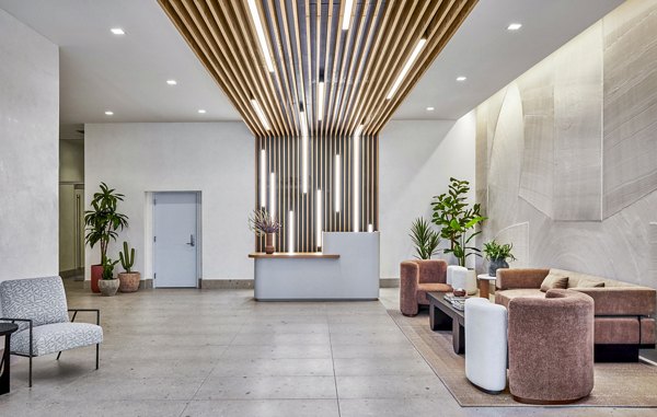 Stylish clubhouse and lobby at Skye on 6th Apartments with modern seating and decor, offering a luxurious welcome to residents and guests