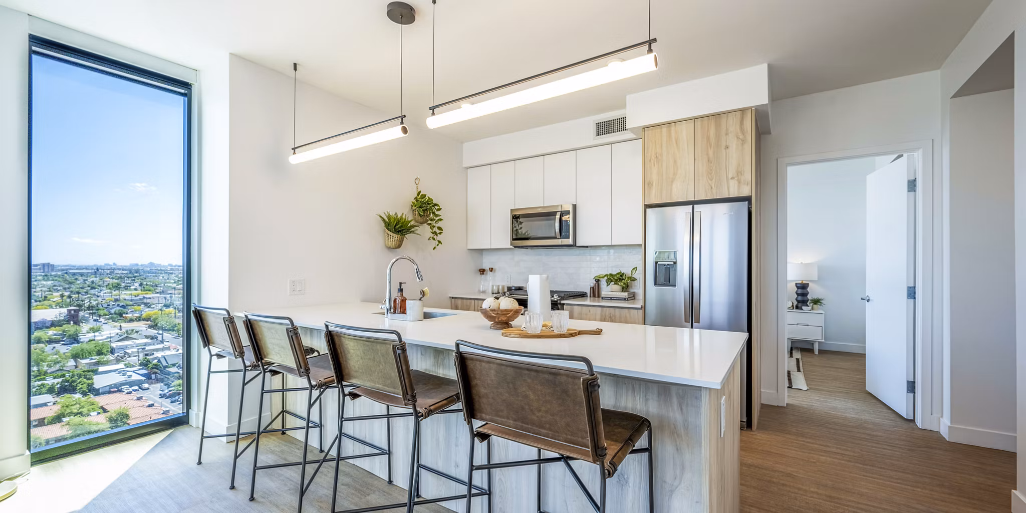 Modern kitchen with stainless steel appliances at Skye on 6th Apartments, luxury property by Greystar
