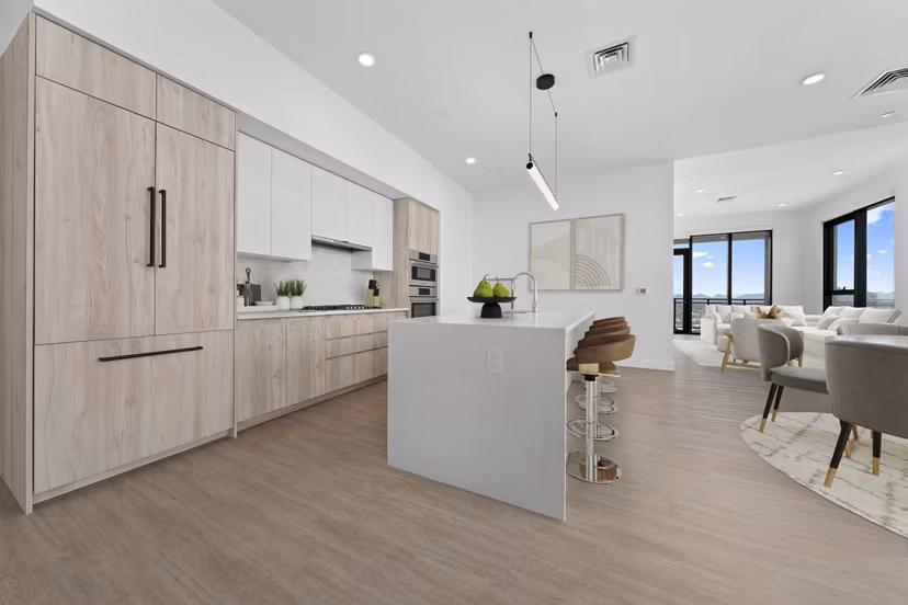 Modern kitchen featuring granite countertops and stainless steel appliances in Skye on 6th Apartments, providing luxury living