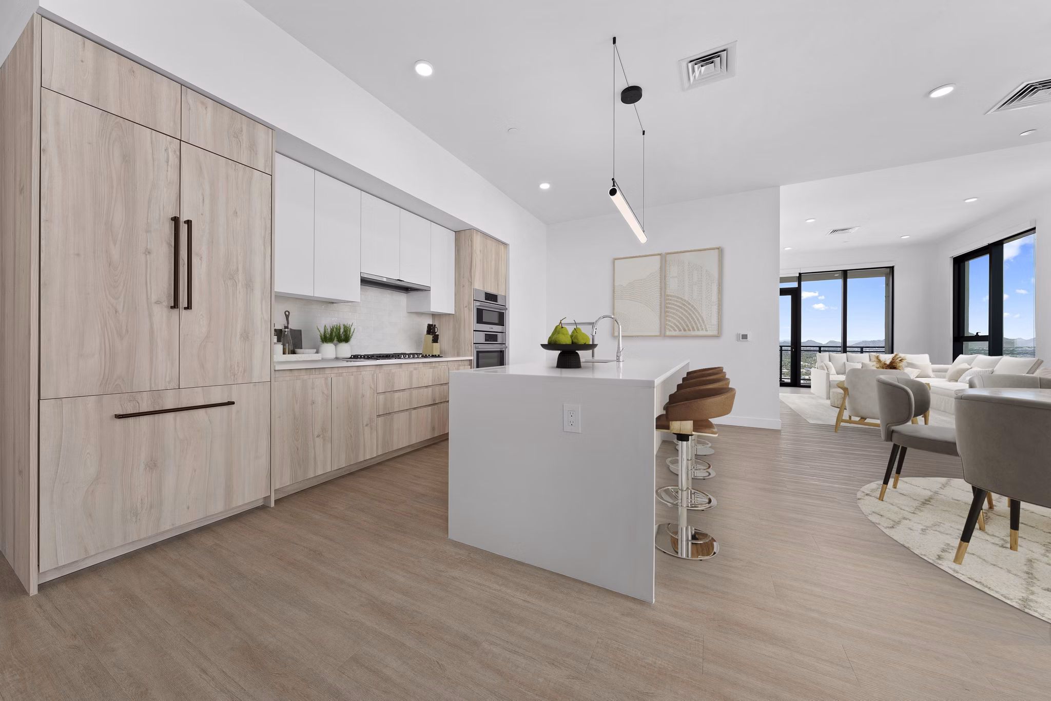 Modern kitchen featuring granite countertops and stainless steel appliances in Skye on 6th Apartments, providing luxury living