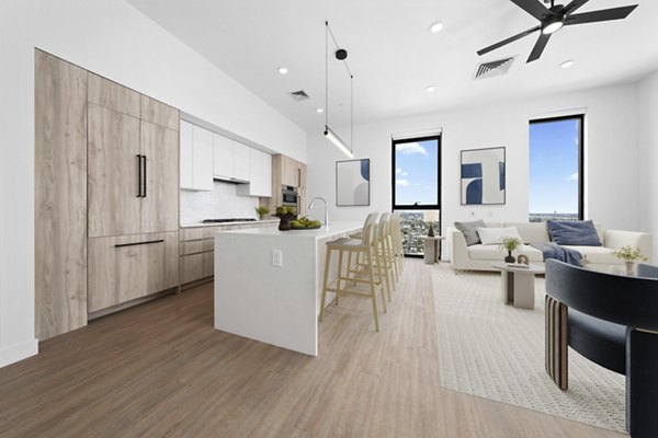 Kitchen featuring modern appliances and granite countertops at Skye on 6th Apartments