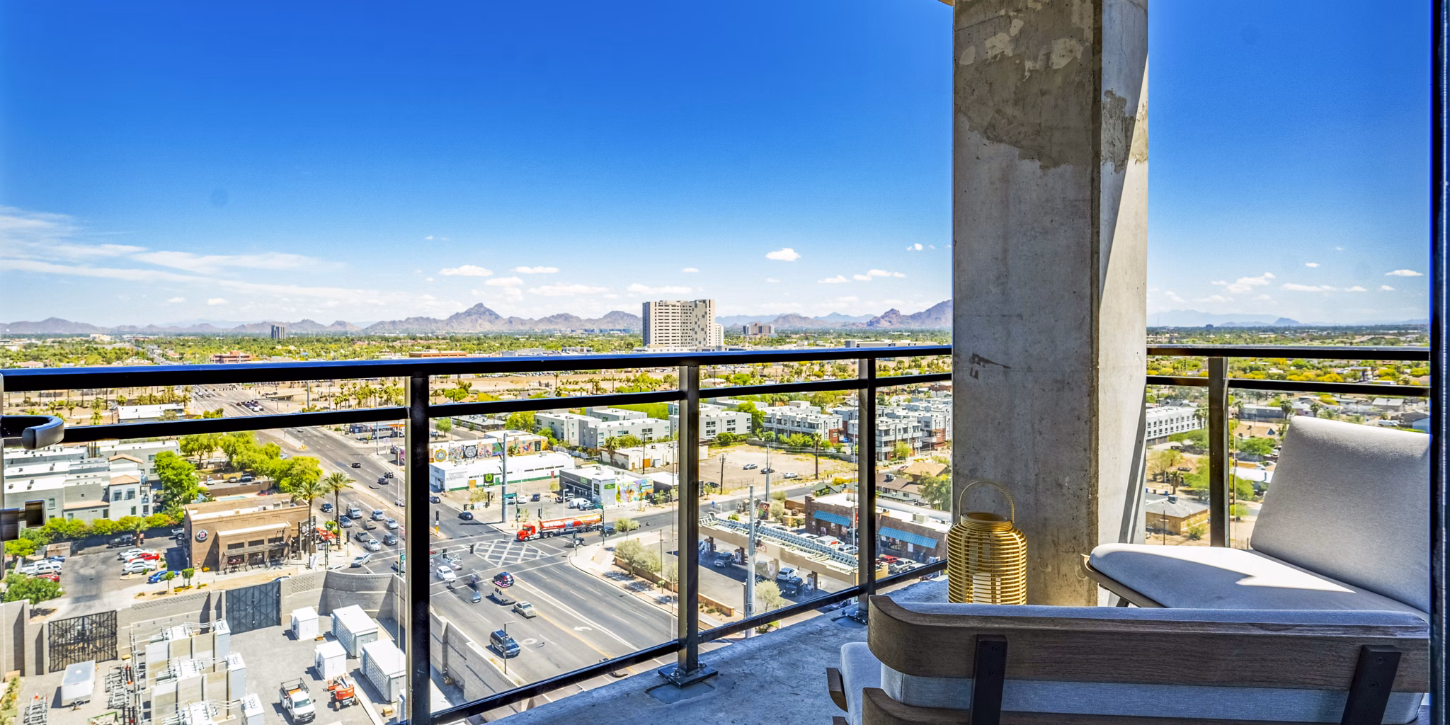 Spacious balcony with outdoor seating at Skye on 6th Apartments, offering luxury outdoor living in urban setting