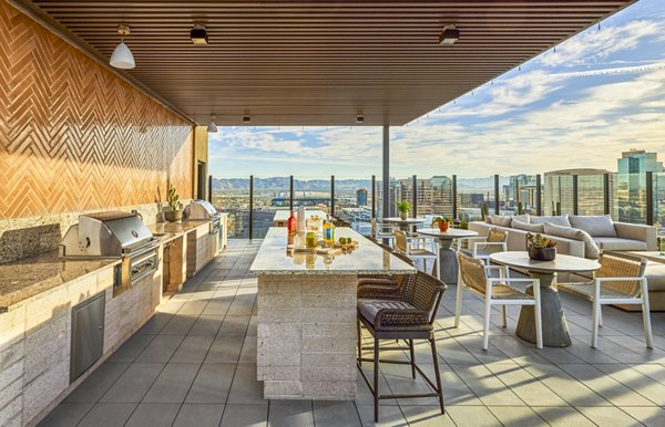 Outdoor grill area on a patio at Skye on 6th Apartments offering a perfect space for entertainment and relaxation