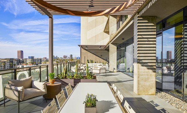 Cozy patio with seating and greenery at Skye on 6th Apartments