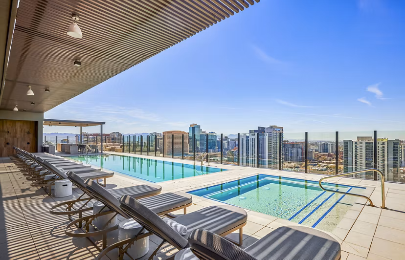 Rooftop pool with city views at Skye on 6th Apartments offering luxury living amenities