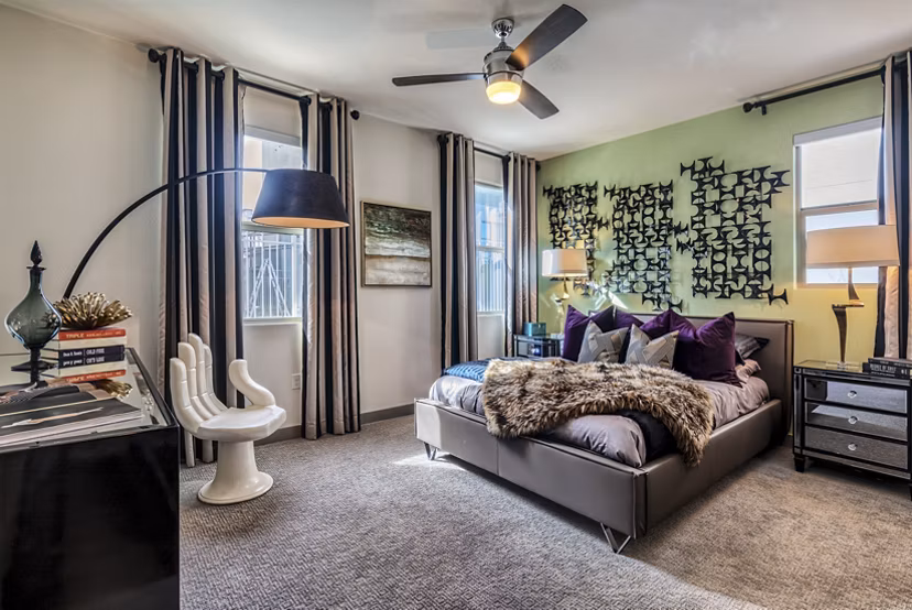 Bedroom featuring modern decor and ample natural light at Constellation Apartments