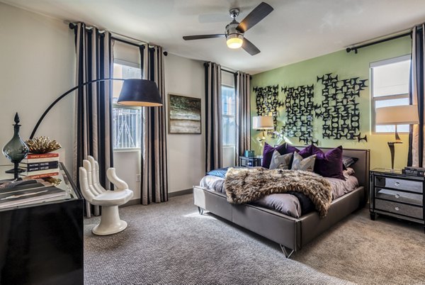Bedroom featuring modern decor and ample natural light at Constellation Apartments