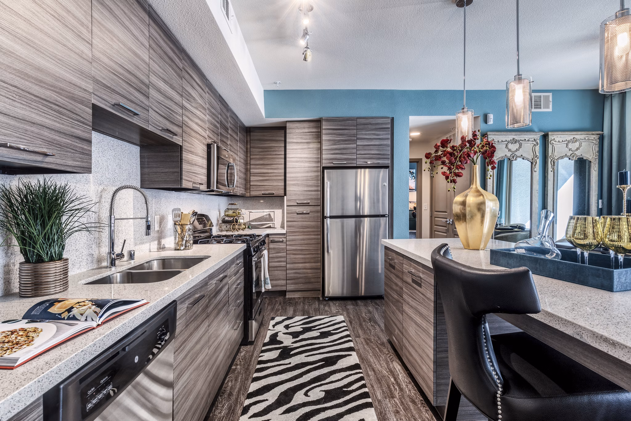 Modern kitchen with sleek countertops and stainless steel appliances in Constellation Apartments