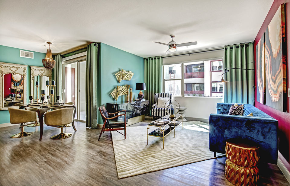 Living room featuring modern furniture and natural light at Constellation Apartments, luxury residence by Greystar