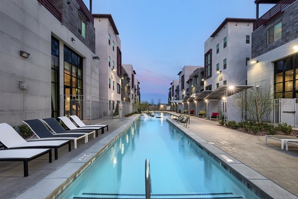 Luxurious pool at Constellation Apartments with elegant sun loungers and modern design Perfect spot for relaxation and recreation