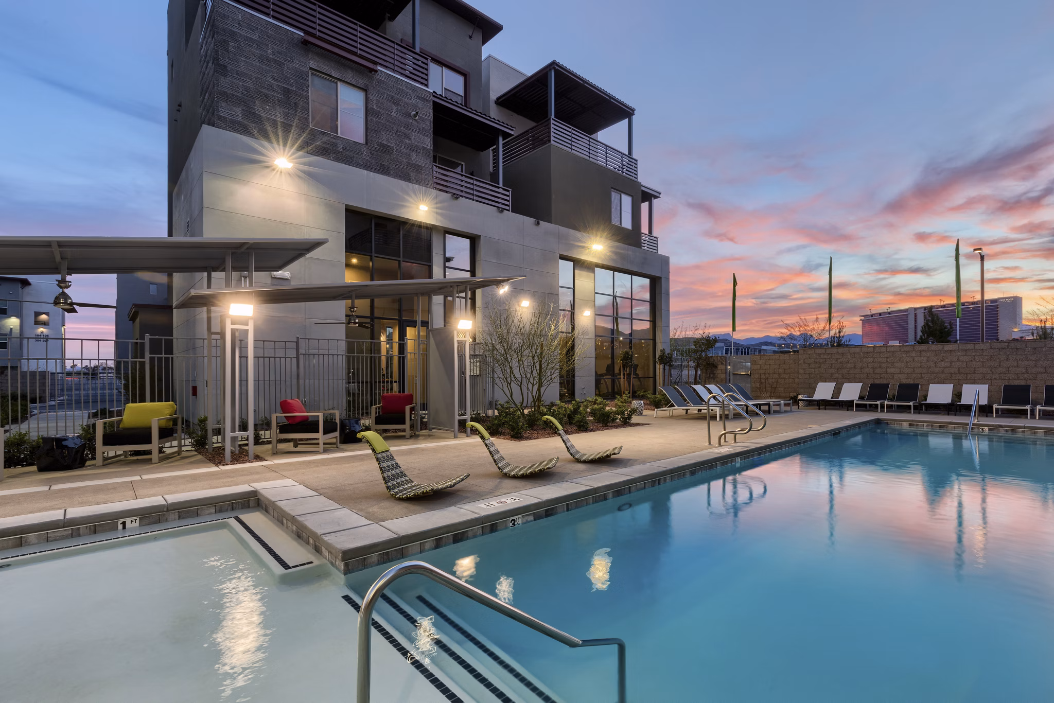 Modern pool with sun loungers at Constellation Apartments