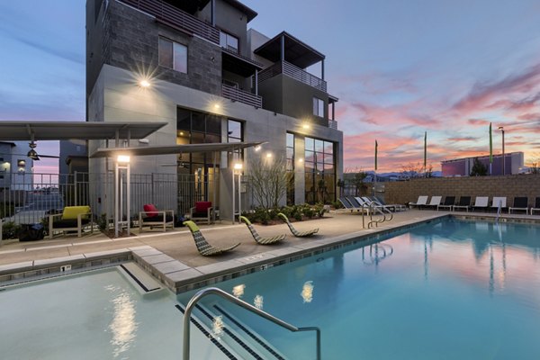 Modern pool with sun loungers at Constellation Apartments