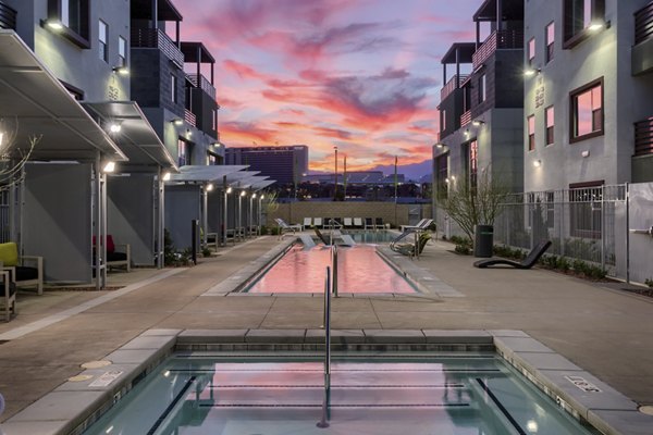 Resort-style pool with modern lounge chairs at Constellation Apartments offering luxury living