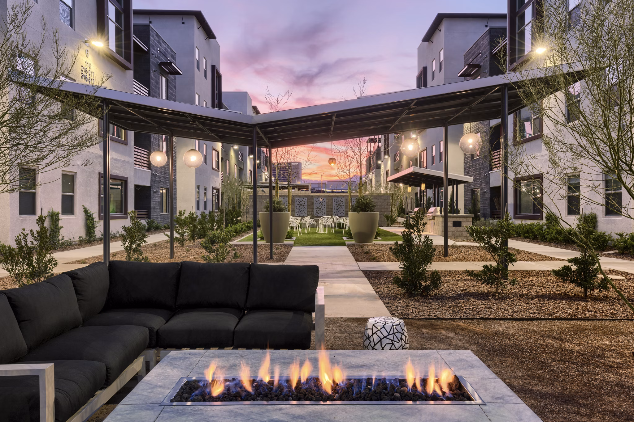 Inviting outdoor fire pit area at Constellation Apartments, ideal for relaxation and social gatherings under the stars
