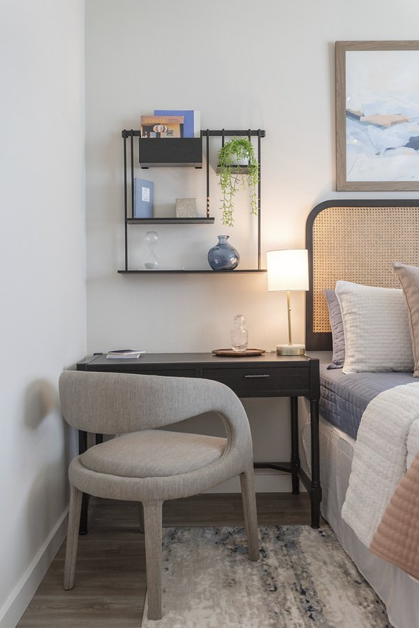 Cozy bedroom with modern furnishings at Prose District West Apartments, showcasing elegant design and comfort for residents