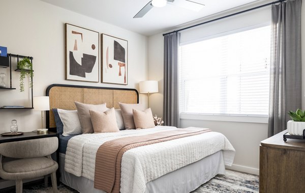 Cozy bedroom featuring modern dÃ©cor and ample natural light in Prose District West Apartments